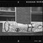 picture of a banner that states "Open your eyes, keep need blind."