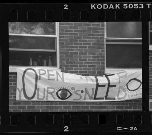 picture of a banner that states "Open your eyes, keep need blind."