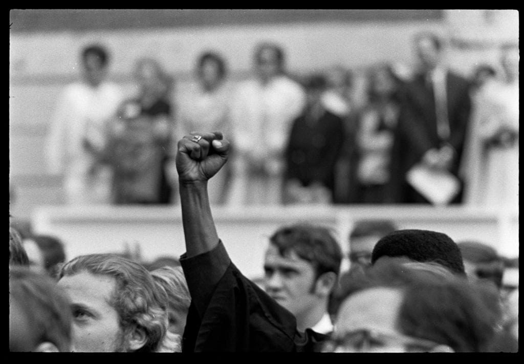 A Black Power fist raised at Commencement 1969.