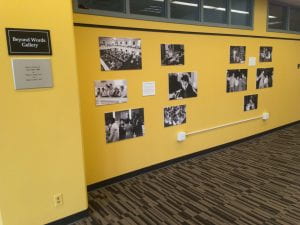 black and white photographs on yellow wall