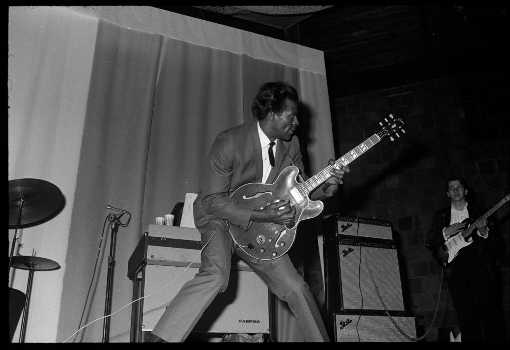 A photograph of Chuck Berry playing the guitar at prom